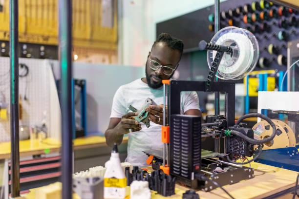 man looking at 3d printer